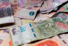 Billetes de pesos argentinos de distintas denominaciones sobre una mesa