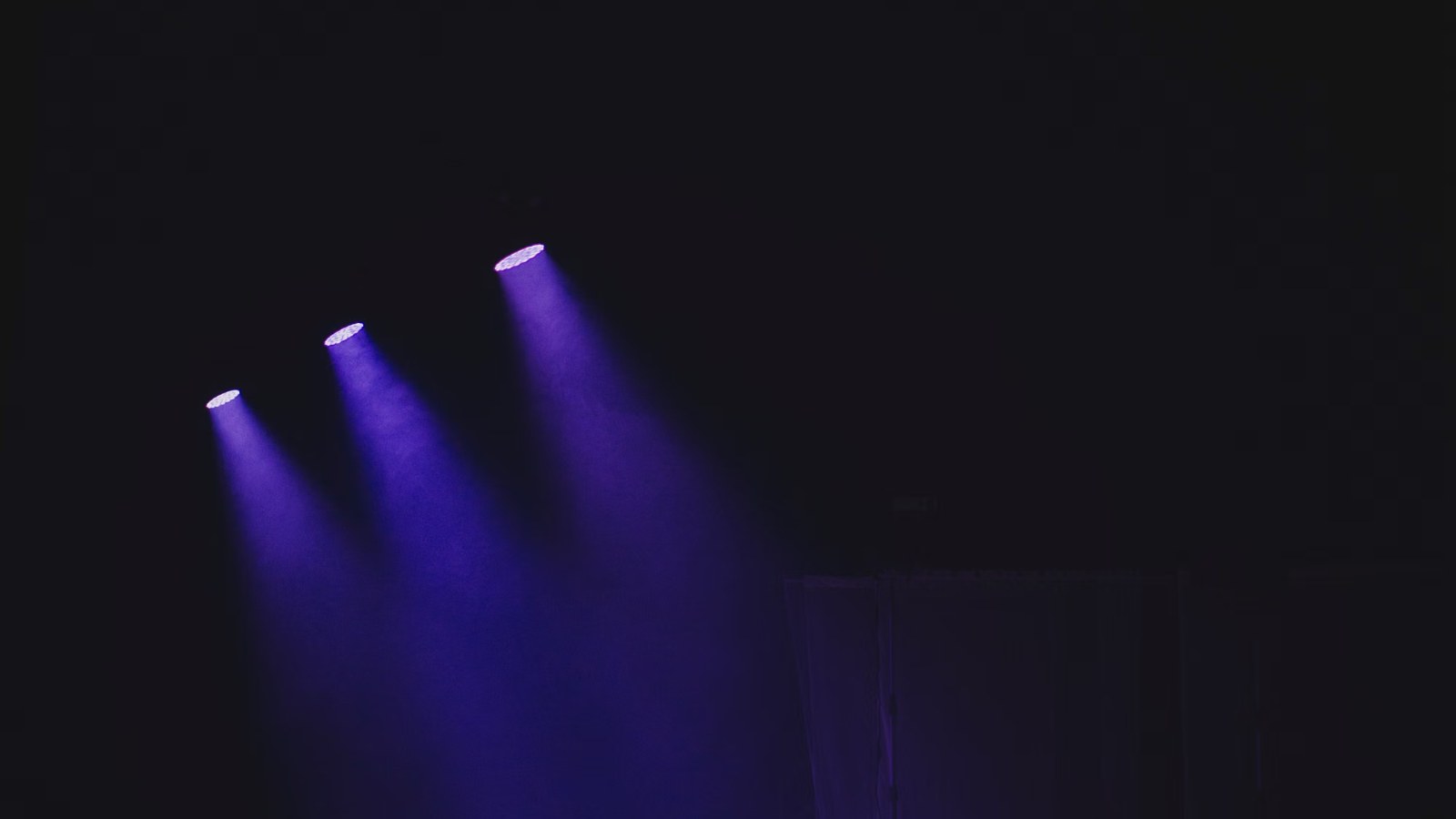 Escenario vacío de un teatro iluminado con reflectores violetas