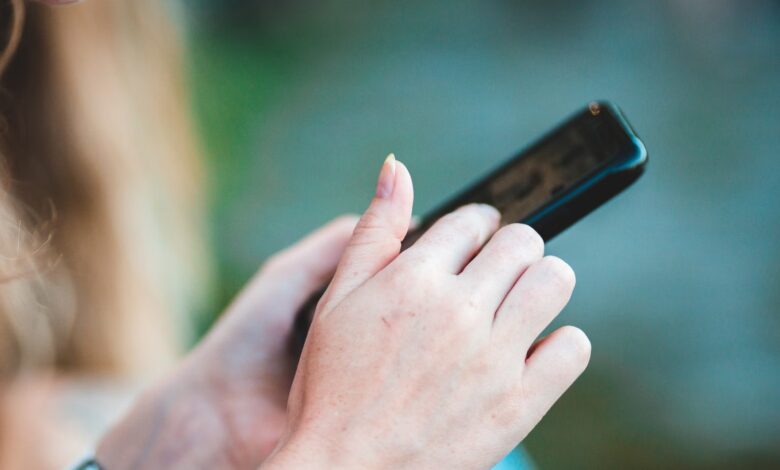 Manos sosteniendo un celular para revisar el almacenamiento