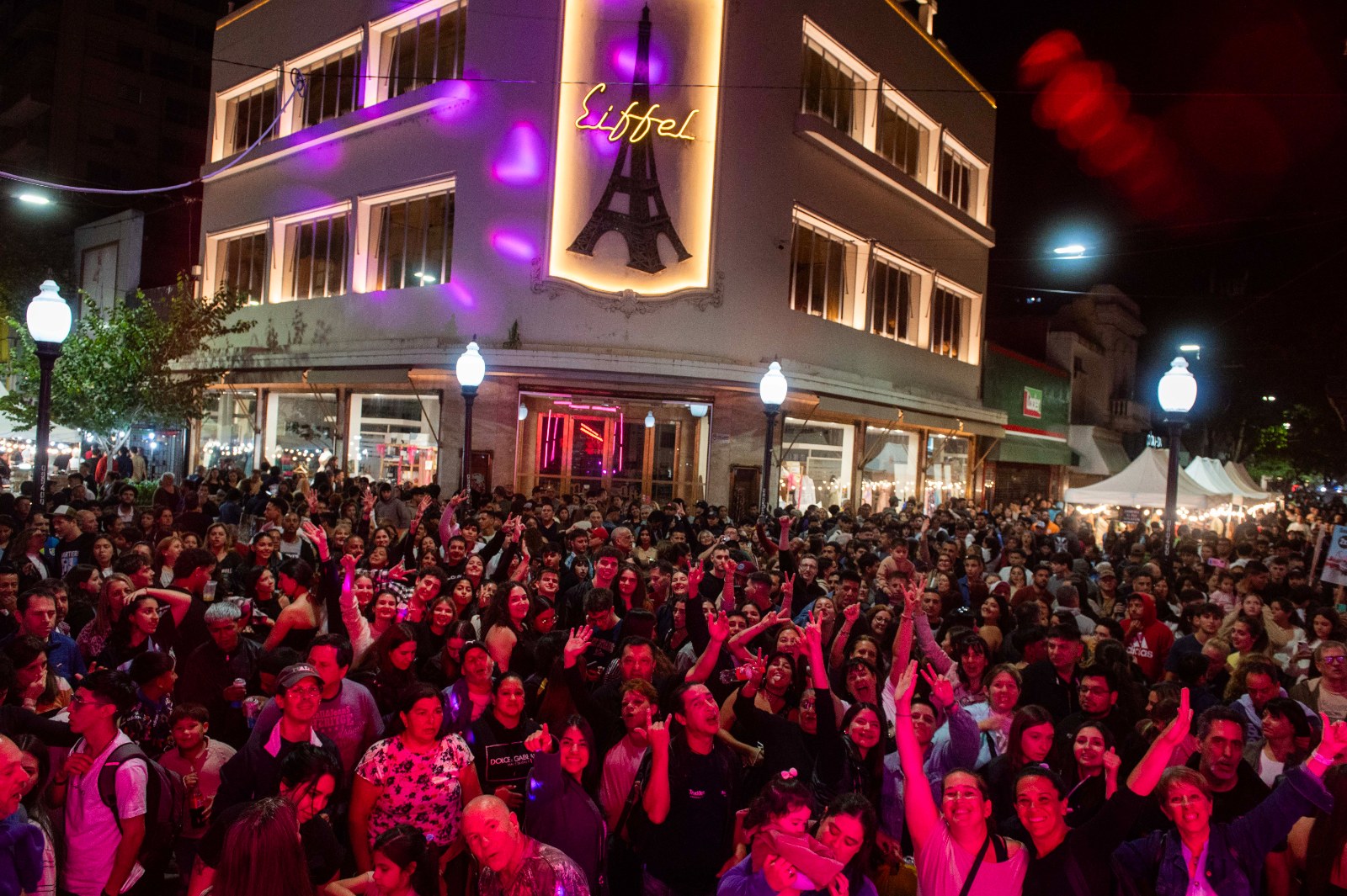 Gente reunida de noche en la peatonal Córdoba durante una Noche de Peatonales en Rosario